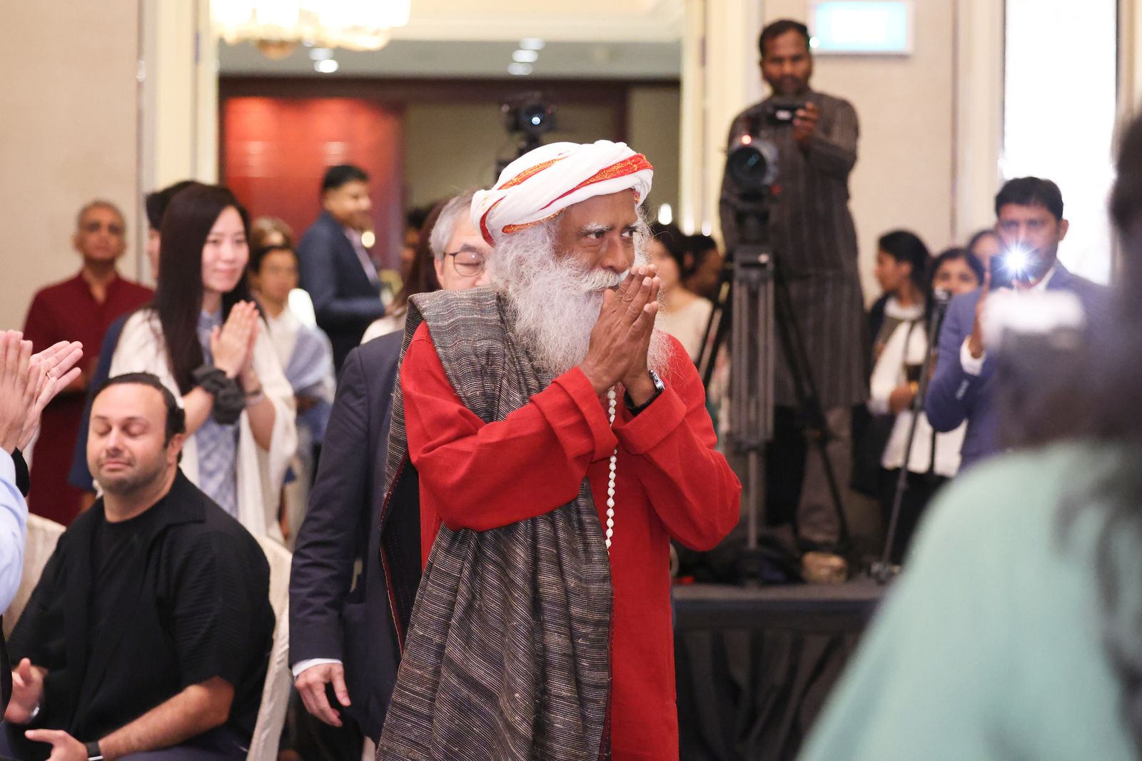 Sadhguru greets the room