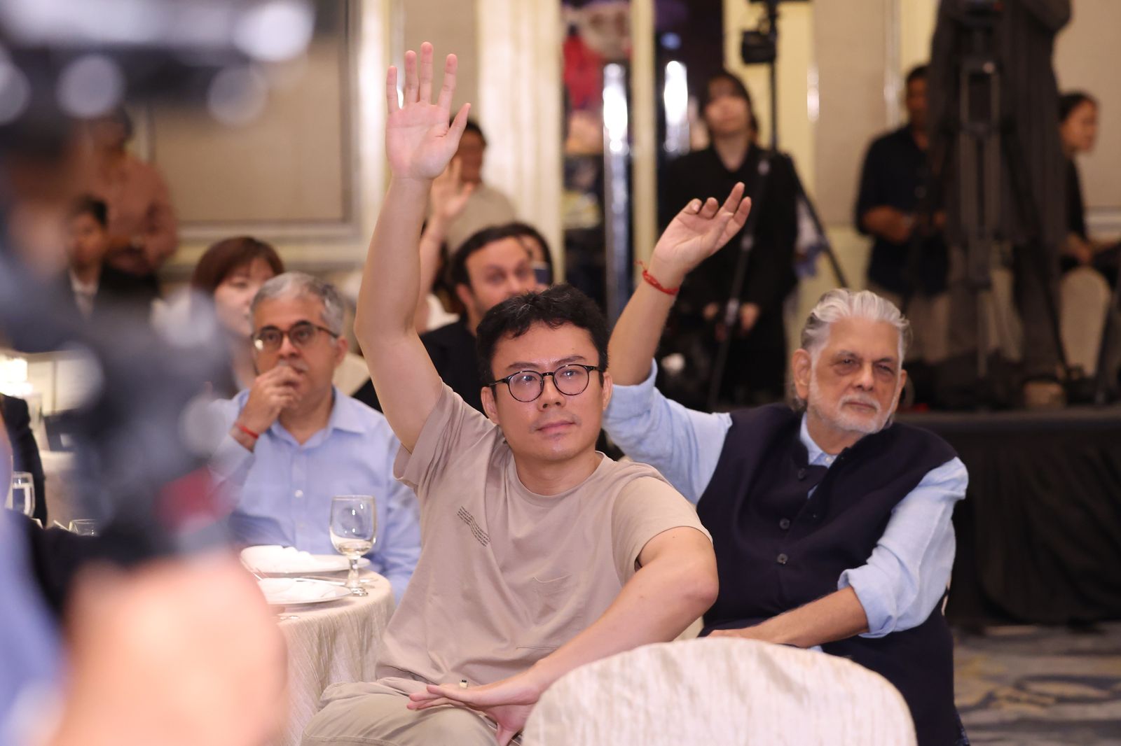 Guests raising their hands to ask questions