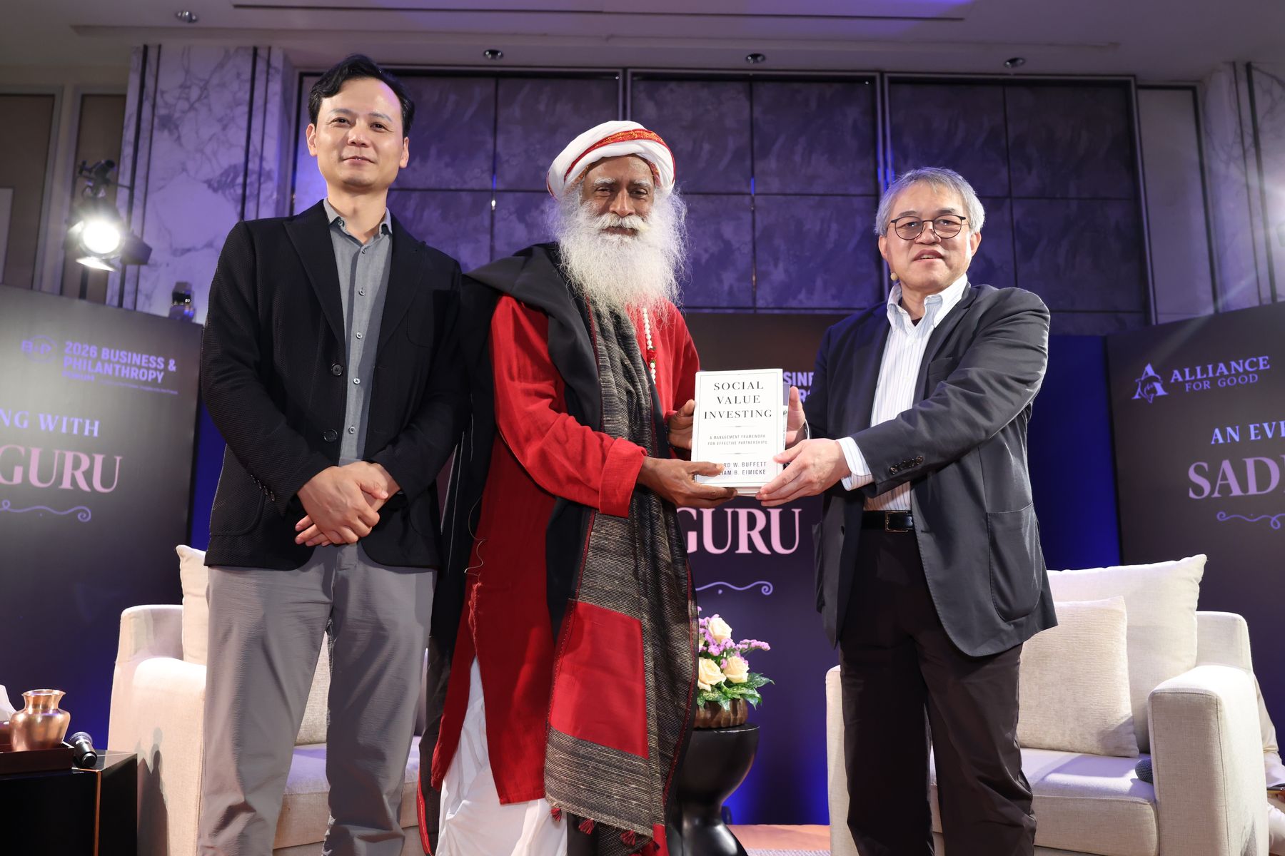 John Wei Zheng and Benjamin Fok Chun-yue with Sadhguru on stage