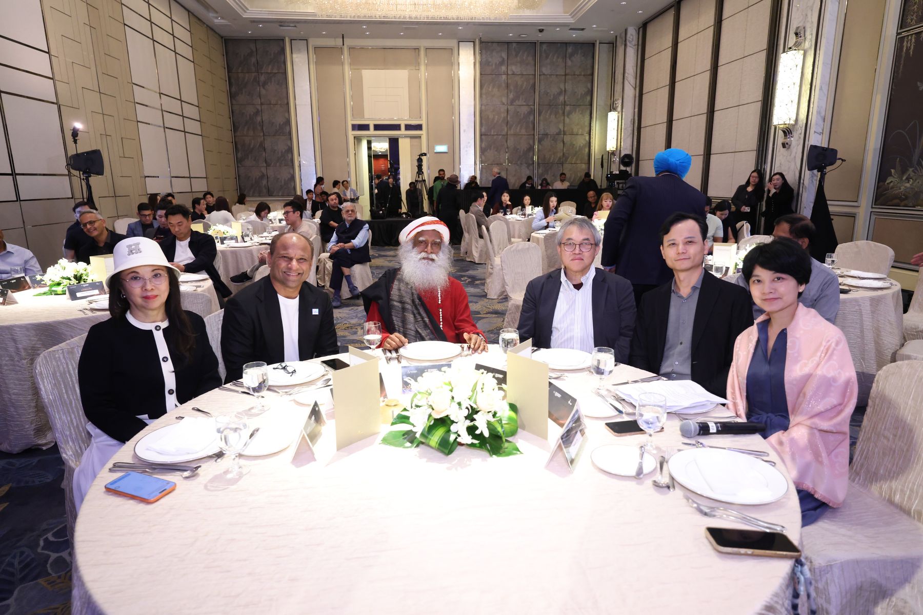 Sadhguru with guests at the head table