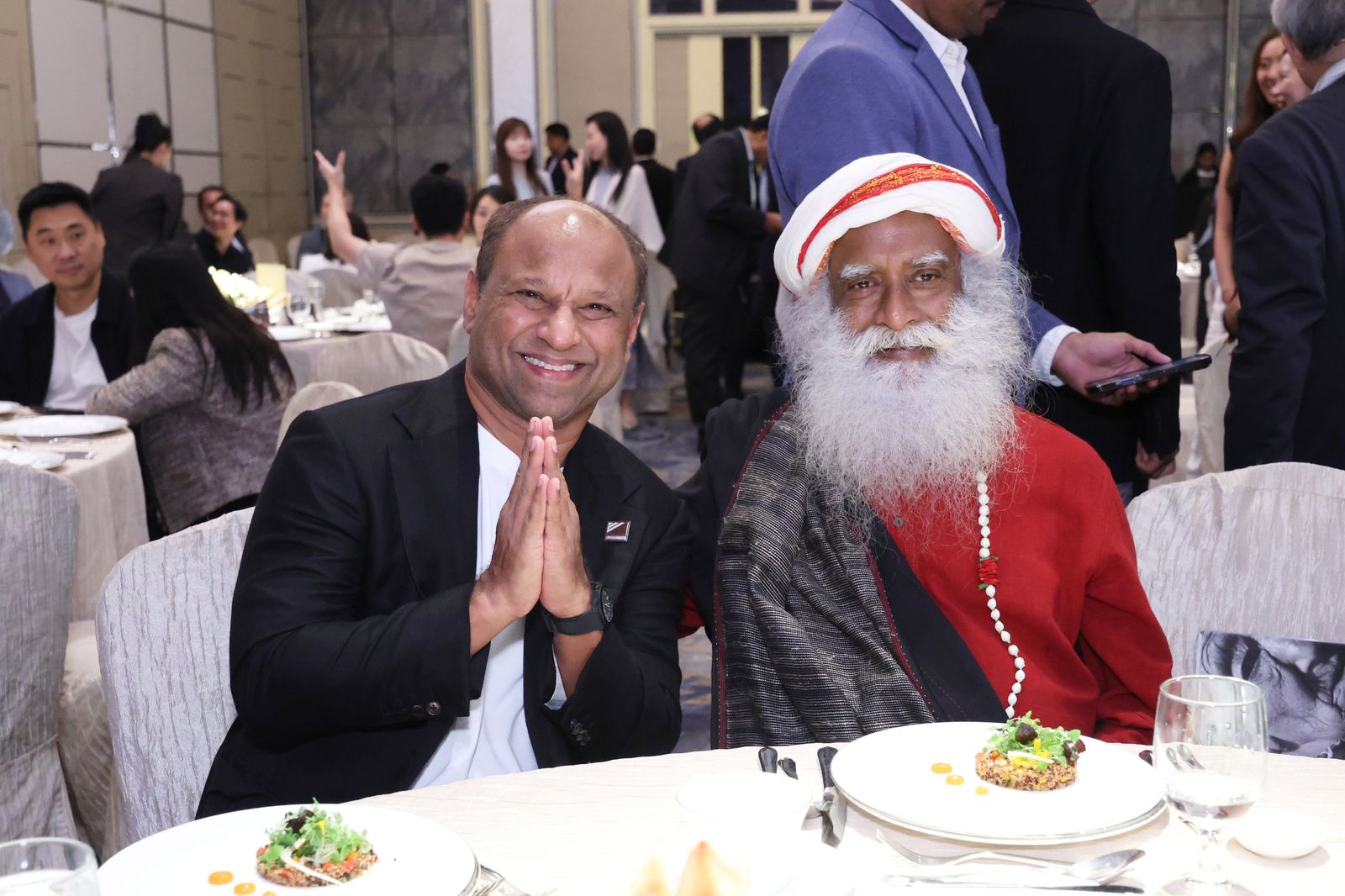 Sadhguru with a guest at dinner